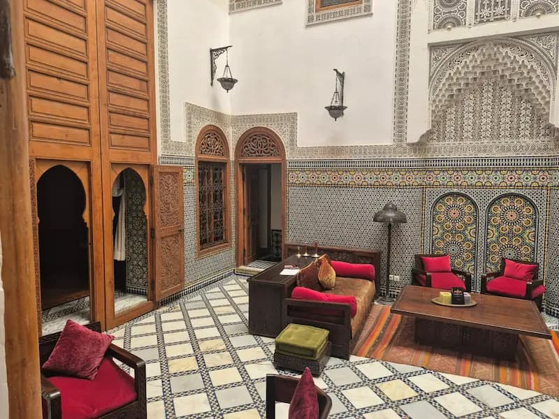 Inner courtyard of a traditional Moroccan riad with pool and authentic Moroccan decoration